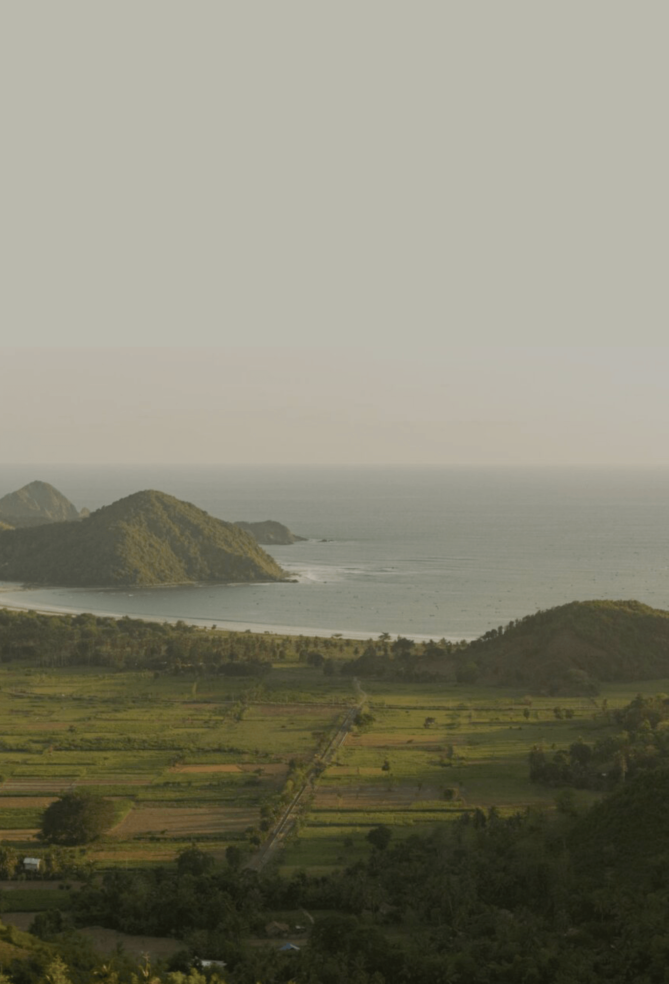 View across Selong Belanak coastline with hills and ocean